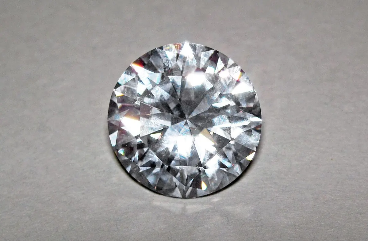 Loose round brilliant cubic zirconia on a light gray background