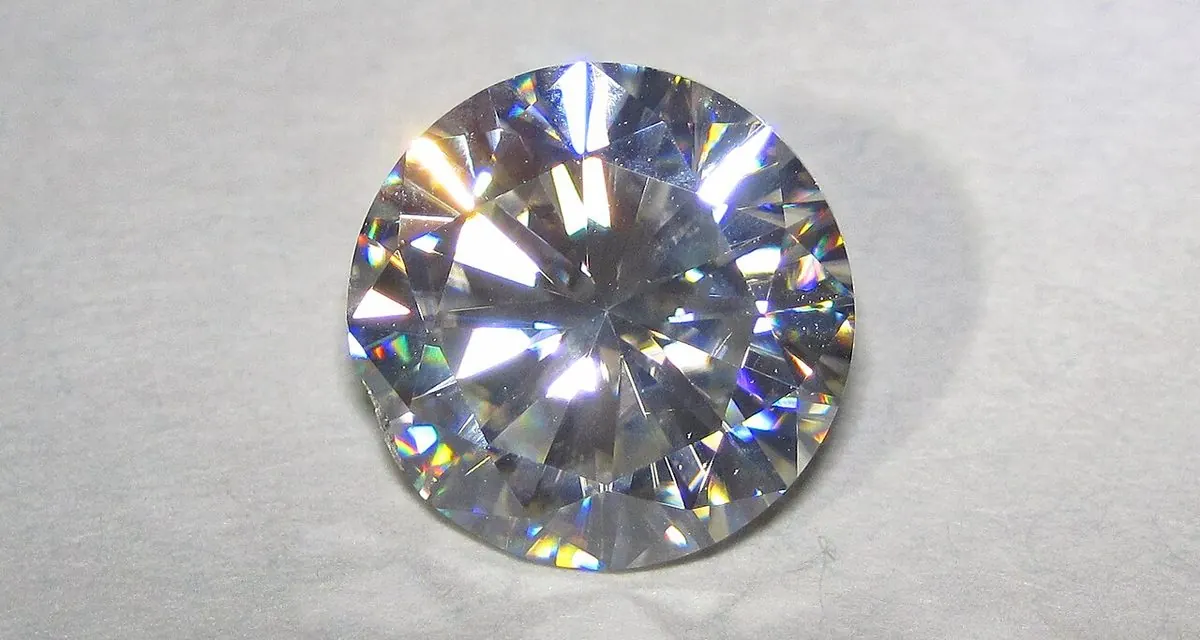A 2.72 carat round moissanite showing strong rainbow colored flashes