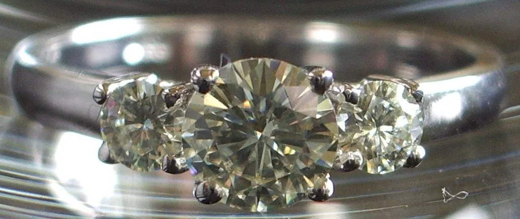 Three stone moissanite engagement ring in white metal